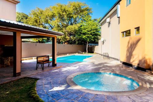 a swimming pool in the backyard of a house at Marangu (3bedroom) in Lusaka