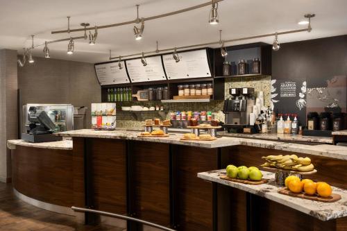 a restaurant with a counter with fruits and vegetables at Courtyard by Marriott Philadelphia Montgomeryville in North Wales
