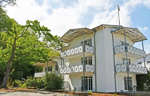 a white building with balconies on it at Appartementhaus am Strand m Balkon Göhren OR 01-09 in Göhren