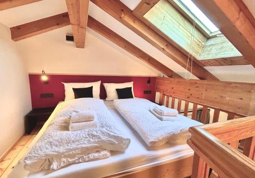 a bedroom with two beds in a attic at Adrian Stoop Seeblick Dachstudio in Bad Wiessee