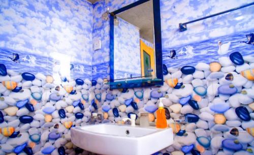 a bathroom with a sink and a wall of balls at WK Villa in Ella