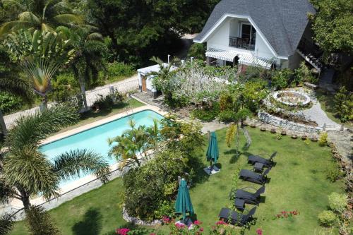 an aerial view of a backyard with a swimming pool and a house at Garden Bungalows Resort in Siquijor