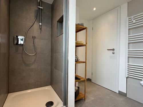 a bathroom with a shower with a tub and a sink at Wohnen auf der historischen Stadtmauer im Herzen von Detmold in Detmold