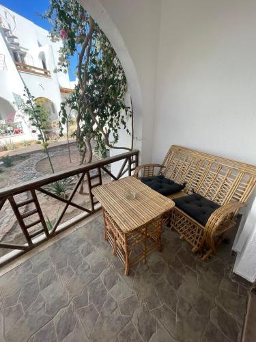 um quarto com uma cama e uma mesa numa varanda em Lovely Chalet in Dahab em Dahab