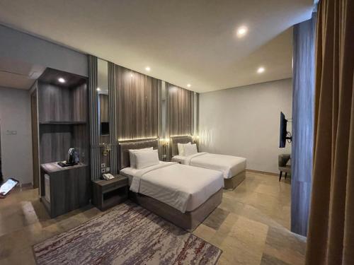 Tempat tidur dalam kamar di Salatin Hotel Palembang