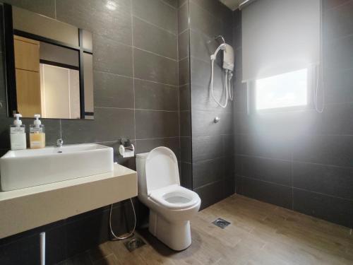 a bathroom with a white toilet and a sink at Mykey The Quartz A-10-09 Melaka City in Melaka