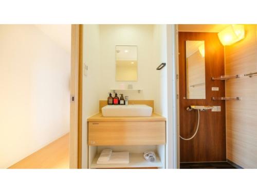 a bathroom with a sink and a mirror at HOTEL ASGARD - Vacation STAY 80328v in Hirakata