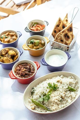 a table topped with bowls of different types of food at Cinnamon Dhonveli Maldives in North Male Atoll