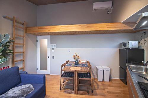 a living room with a table and a loft bed at - 旅time 沐の花 - Kinohana 新築戸建 粉浜駅 in Osaka