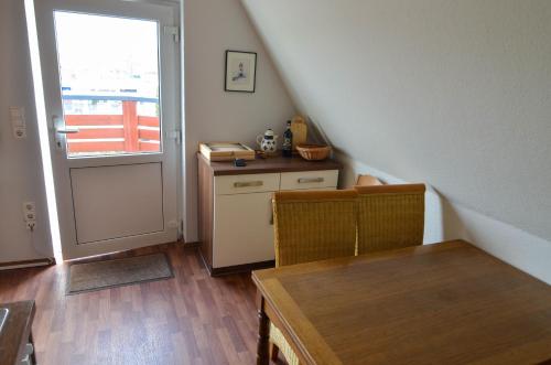 a room with a staircase with a table and a door at Burhave Gästehaus 7 in Butjadingen