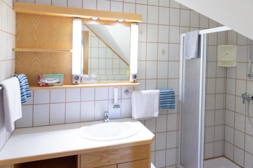 a bathroom with a sink and a mirror at Gästehaus Nora in Stein