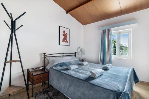 - une chambre avec un lit et une couette bleue dans l'établissement Angela Apartment, à Dhalamanára