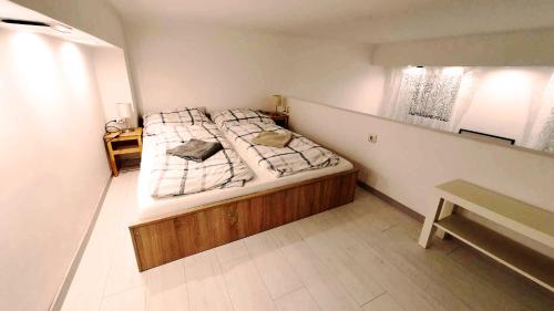 a bedroom with a large bed with a wooden frame at Pinball Apartment in Budapest