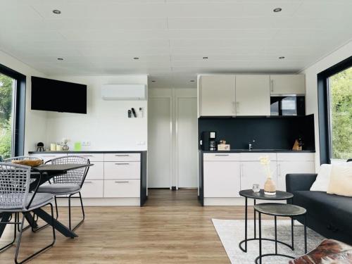 a kitchen and living room with a couch and a table at Floatinghouses Weserbergland in Höxter