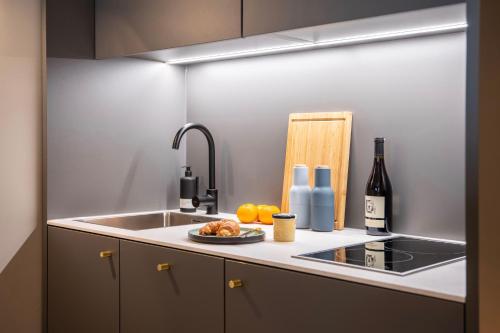 a kitchen with a sink and a plate of food at ipartment Leverkusen in Leverkusen