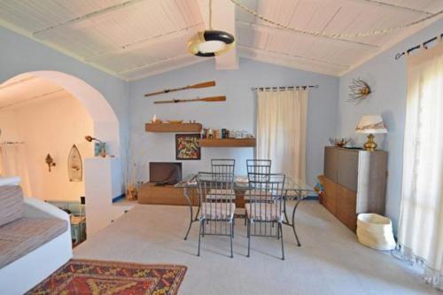 a living room with a dining table and chairs at Villa Redinoce in Marciana