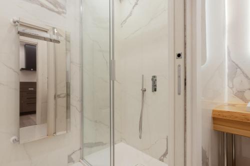 a shower with a glass door in a bathroom at San Nicolò Suites in Trieste