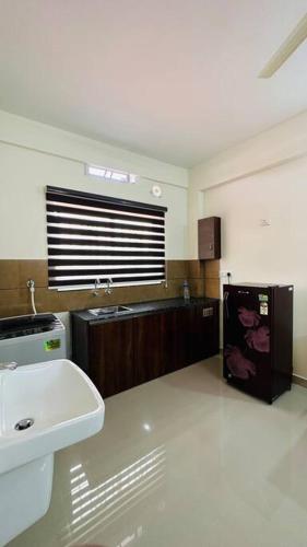 a bathroom with a white sink and a sink at Peaceful Living Solo Suites in Ernakulam
