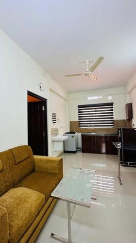 a living room with a couch and a table at Peaceful Living Solo Suites in Ernakulam