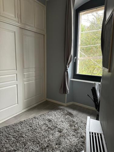 a room with a door and a rug next to a window at Belle Lauragaise ensoleillée in Issel