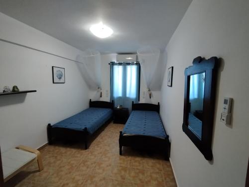 a room with two beds and a mirror at On the sea 2 in Mochlos
