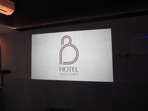 a sign for a hotel on a wall at B Hotel Kuala Lumpur in Kuala Lumpur