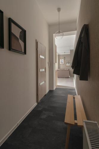 a hallway with a bench and a room at HARBOR APARTMENTS - Damrota in Katowice