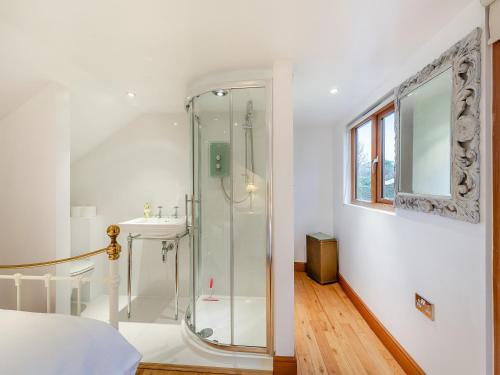 a bathroom with a glass shower and a sink at Little Batley House in Westgate-on-Sea