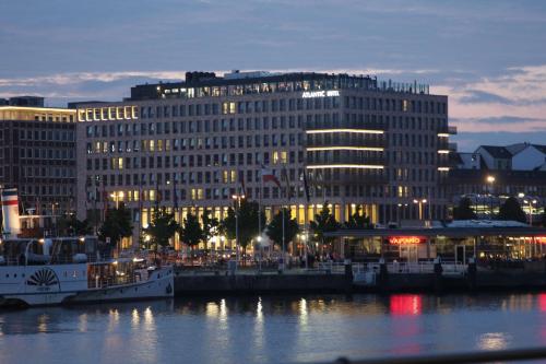 een groot gebouw naast een waterlichaam bij Atlantic Hotel Kiel in Kiel