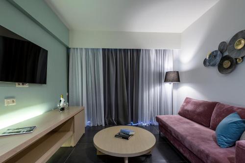 a living room with a couch and a table at Atlantica Mikri Poli Kos in Kardamaina