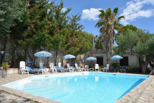 uma piscina com cadeiras e guarda-sóis em Casa Vacanze Villa Francy em Marina di Camerota