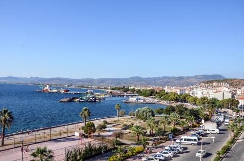 a city with a harbor and boats in the water at Perla Hotel in Dikili