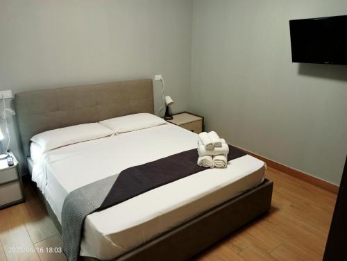 a bedroom with a bed with a stuffed animal on it at Residenza delle Nazioni in Gatteo a Mare