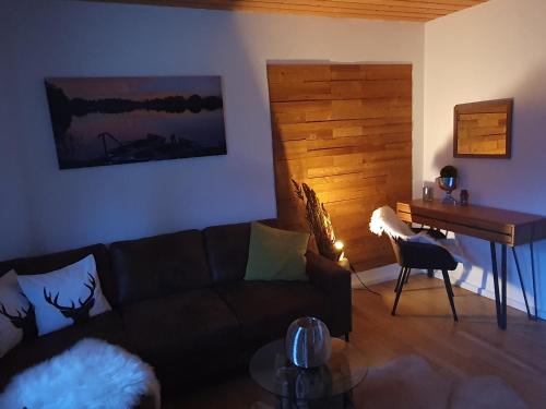 a living room with a couch and a piano at Alpenblick in Oberammergau