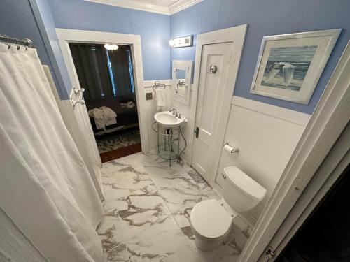 a bathroom with a toilet and a sink at Florida Vacation House - Pensacola East Hill in Pensacola