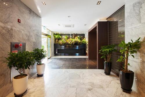 a lobby with potted plants in a building at Wolmido Premiers Hotel in Incheon