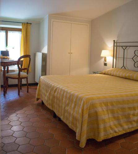 a bedroom with a bed and a table and a dining room at Da Gin in Castelbianco