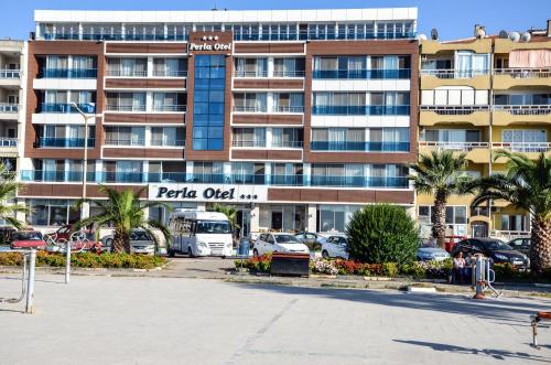 a parking lot in front of a large building at Perla Hotel in Dikili