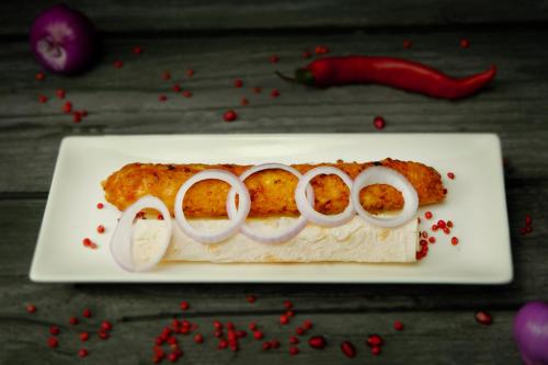 a plate of food with onion rings on it at VinoOdor - ვინოოდორ in Tʼelavi