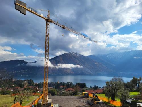 a construction crane in front of a body of water at Casa del Net - Tremezzo in Tremezzo