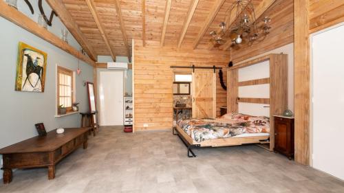 a bedroom with a bed and a wooden ceiling at Best Boerderij B&B in Best