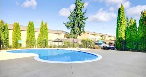 a swimming pool in a yard with trees at Casa Bella Homes - Top floor 2-BR 1 Bath Condo, Centrally located in Federal Way