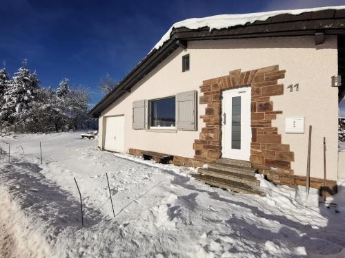 a house is covered in snow at Auszeit, Erholung mitten in der Natur - Ferienhaus im Sauerland in Faulebutter in Finnentrop