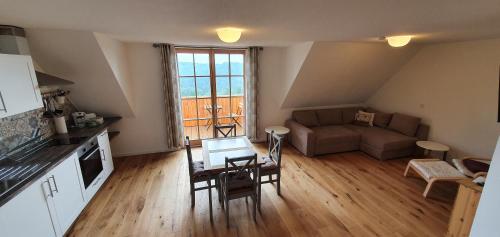 a living room with a couch and a table at Lana Salta Alpakas - Gemütliche Ferienwohnungen auf dem Bauernhof in Murrhardt