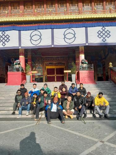 a group of people sitting in front of a building at Amaira Resort & Farms - Mirik, West Bengal in Mirik