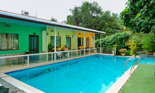 a house with a swimming pool in front of it at Cali Hill Resort in Phú Quốc