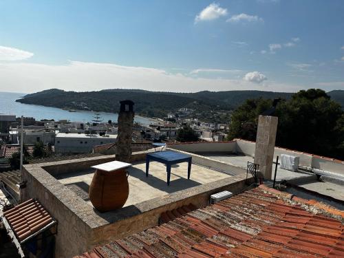 a blue bench sitting on top of a roof at Apo Petra in Agia Marina Aegina