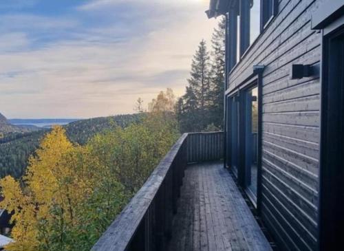a balcony of a house with a view of the mountains at Lommedalen Panorama 55m2 in Bærums Verk