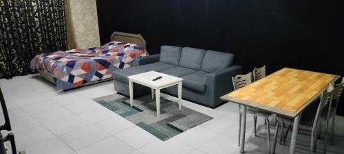 a living room with a couch and a table at Private Room with Separate Bathroom and balcony in Ajman 