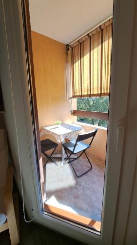 a view of a room with a table and a window at Studio Meublé Cures thermales avec vue in Gréoux-les-Bains